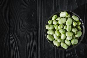 fresh greens broad beans fava on a dark background photo