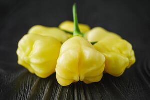 fresh delicious chili pepper aji white fantasy on a dark wooden rustic background photo