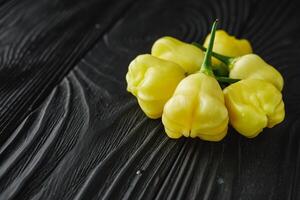 fresh delicious chili pepper aji white fantasy on a dark wooden rustic background photo