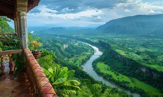 A panoramic view of a winding river through a lush valley, seen from a balcony of a highland retreat photo