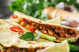 set of delicious fresh colorful quesadilla on a dark background photo