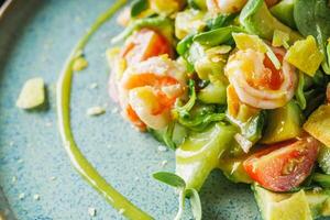 delicious fresh salad with shrimp and avocado on a beautiful plate photo