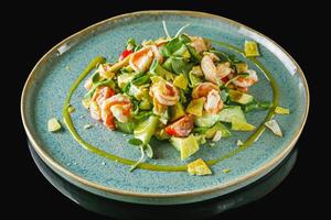 delicious fresh salad with shrimp and avocado on a beautiful plate photo
