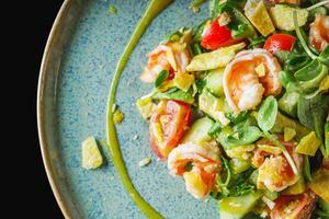 delicious fresh salad with shrimp and avocado on a beautiful plate photo