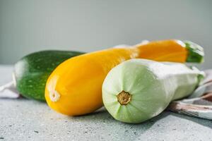 fresh natural zucchini on a light stone background photo