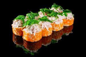 sushi roll with crab tobiko cucumber cream chukka cheese on a black mirror background photo