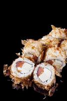 sushi roll with salmon tofu cream cheese on a black mirror background photo
