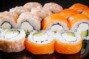 sushi roll with shrimp Ebby cream cheese Philadelphia avocado cucumber on a black mirror background photo