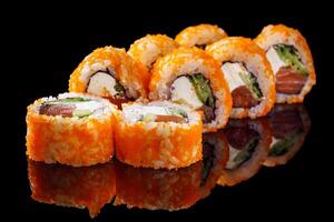 sushi roll with salmon cream cheese tobiko avocado and cucumber on a black mirror background photo