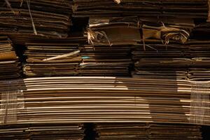 Stack of corrugated paper waste before sending to shred and recycle at recycling plant. Corrugated fiberboard. Old, randomly folded paper. photo