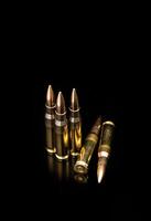 Bullet isolated on black background with reflexion. Rifle bullets close-up on black back. Cartridges for rifle and carbine on a black. photo