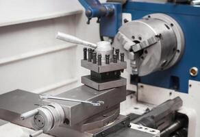 Lathe for metal processing in a workshop. A modern lathe for processing metal and other materials. photo