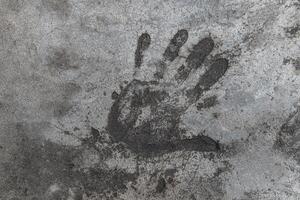 Handprint on cement. Memorable handprint of a hand in an old concrete wall. Copy space for text. photo