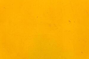 The metal surface is rough, with smudges, painted with yellow paint. Bright colored back. photo