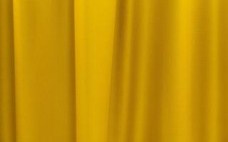 Fabric yellow curtains. Abstract background, curtain, drapes gold fabric. Crumpled cloth, folds of fabric. photo