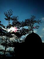 view of a silhouette of the elegance mosque dome with clear blue sky for eid mubarak, ramadan. Celebrating tranquil Islamic style photo