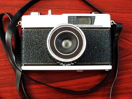 old vintage camera gear on wooden table background. top view, flat lay. Retro vintage concept. Travel and journey design element photo
