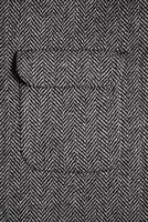 The texture of the fabric for the coat. Closeup of wool herringbone fabric. weed, Wool Background Texture. photo