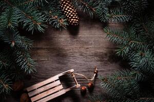 Christmas frame from fir branches on a background of an old gray board around an open notebook with blank sheets. Frame of fir branches. Christmas card blank concept. photo