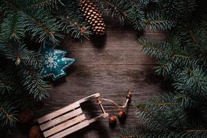 Christmas frame from fir branches on a background of an old gray board around an open notebook with blank sheets. Frame of fir branches. Christmas card blank concept. photo