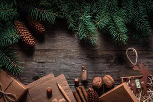 Christmas green frame from fir branches on a vintage gray board background. Frame of fir branches. Christmas card blank. photo
