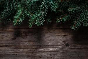 Christmas green frame from fir branches on a vintage gray board background. Frame of fir branches. Christmas card blank. photo