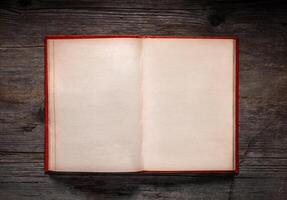 Vintage book, open, on old wooden table, with clipping path. Open Book blank on old wooden background. book with blank pages photo