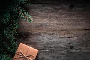 Christmas green frame from fir branches on a vintage gray board background. Frame of fir branches. Christmas card blank. photo