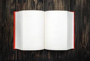 Book, open, on old wooden table, with clipping path. Open Book blank on old wooden background. book with blank pages photo