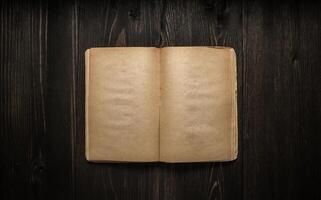 Vintage book, open, on old wooden table, with clipping path. Open Book blank on old wooden background. book with blank pages photo