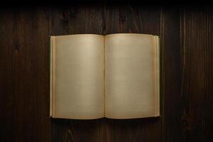 Vintage book, open, on old wooden table, with clipping path. Open Book blank on old wooden background. book with blank pages photo