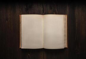 Vintage book, open, on old wooden table, with clipping path. Open Book blank on old wooden background. book with blank pages photo