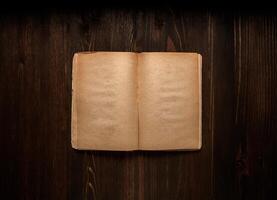 Vintage book, open, on old wooden table, with clipping path. Open Book blank on old wooden background. book with blank pages photo