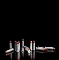 Bullet isolated on black background with reflexion. Rifle bullets close-up on black back. Cartridges for rifle and carbine on a black. photo