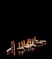 Bullet isolated on black background with reflexion. Rifle bullets close-up on black back. Cartridges for rifle and carbine on a black. photo