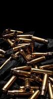 Empty shells from weapons on black smoldering coals. Consequences of the war. Dark back. photo
