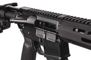 Modern automatic rifle isolated on black background. Weapons for police, special forces and the army. A carbine with optical, mechanical sights and a silencer on a dark back photo