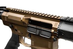 Modern automatic rifle isolated on white background. A gold-coloured weapon with a carbon forearm and barrel. Assault rifle on white back. Automatic carbine. photo