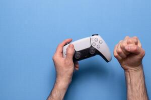 Hand hold new joystick. Gamer play game with gamepad controller. Gaming man holding simulator joypad. Person with keypad joystic in arms. photo