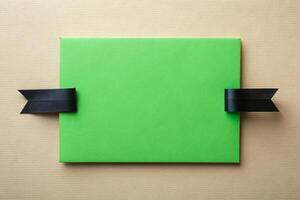 Black ribbon tape with a rectangle with green background for your presentation background photo