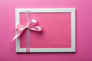 White ribbon tape with a rectangle with pink background for your presentation background photo