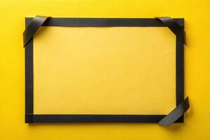 Black ribbon tape with a rectangle with yellow background for your presentation background photo
