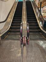 Escalator at the corner of a shopping center building in Bandung, West Java, Indonesia photo