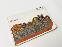 BNI savings book with orange and white design. Indonesia, Sibolga, 10 August 2024. photo