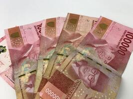 five pieces of Indonesian currency denomination of one hundred thousand rupiah. photo