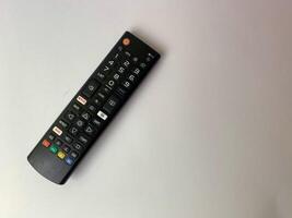 a tv remote on a white background. photo