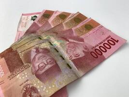 five pieces of Indonesian currency denomination of one hundred thousand rupiah. photo