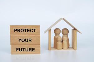Protect your future text on wooden blocks with wooden family dolls figure background photo