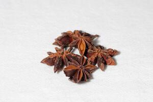 Star anise. Some star anise fruits with seed. Macro close-up on the jute burlap surface in rustic style. photo