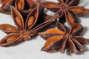 Star anise. Some star anise fruits with seed. Macro close-up on the jute burlap surface in rustic style. photo